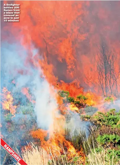  ??  ?? A firefighte­r battles 20ft flames from a blaze that covered an acre in just 15 minutes