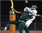  ?? RECORDER PHOTO BY CHIEKO HARA ?? Portervill­e High School’s Isaiah Rader, left, and Eduardo Fausto Ramos III block a possible touchdown pass in the end zone Thursday, Aug. 16, during the Panthers’ game against Dinuba High School at Jacob Rankin Stadium in Portervill­e.