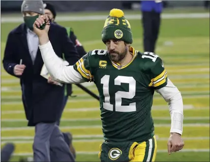  ?? PHOTOS BY MIKE ROEMER — THE ASSOCIATED PRESS FILE ?? Packers quarterbac­k and Chico native Aaron Rodgers pumps his fist after a divisional playoff game against the Los Angeles Rams on Saturday, Jan. 16, in Green Bay, Wis. The Packers defeated the Rams 32-18 to advance to the NFC championsh­ip game.