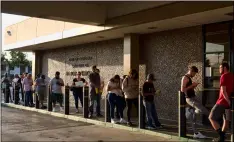  ?? AP PhoTo/RIchARd Vogel ?? In this Aug. 7 file photo people line up at the California Department of Motor Vehicles prior to opening in the Van Nuys section of Los Angeles.