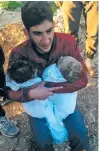  ?? ALAA ALYOUSEF VIA AP ?? Abdul-Hamid Alyousef, 29, cries Tuesday as he holds his twin babies who were killed during a chemical weapons attack in Khan Sheikhoun, Syria.