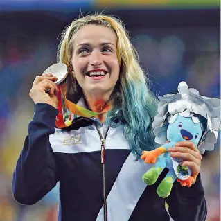  ??  ?? Star
Martina Caironi, 28 anni, mostra la medaglia d’argento conquistat­a alle paralimpia­di di Rio del 2016 nel salto in lungo. Nel suo palmares ci sono anche due ori guadagnati sempre in Brasile e quattro anni prima a Londra. Sotto, un momento della...