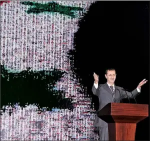  ?? AP/SANA ?? Syrian President Bashar Assad speaks at the Opera House in central Damascus on Sunday in this photo released by the Syrian official news agency SANA. It was Assad’s first public speech in six months.