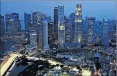  ?? Picture: REUTERS ?? POLARITIES: Singapore's central business district skyscraper­s in this file picture. Grade-A office rents may rise 11% this year as a lack of supply until mid-2016 helps boost leases.