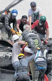  ?? AP ?? ABOVE An injured man is pulled out of a building that collapsed during an earthquake in Mexico City on Tuesday.