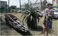  ??  ?? WALKING tour guide, Alison Chadwick, stands next to the remains of one of the small boats used to transport passengers from ship to shore.