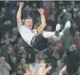  ?? AFP ?? Teammates throw Germany forward Lukas Podolski in the air.