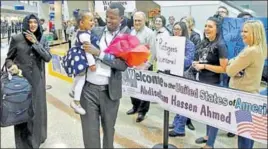  ?? AP FILE ?? A Somali refugee who had been stuck in limbo after President Donald Trump temporaril­y banned refugee entries, walks with his wife and his daughter at Salt Lake City airport.
