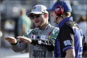  ?? LM OTERO — THE ASSOCIATED PRESS ?? Dale Earnhardt Jr. speaks to a crew member before qualifying for NASCAR Cup series auto race at Texas Motor Speedway in Fort Worth, Texas, Friday.