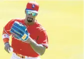  ?? PHOTO AP FILE ?? In this photo from Feb. 23, Phillies outfielder Andrew McCutchen fields a ball during spring training practice at Spectrum Field in Clearwater, Fla.