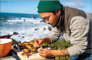  ?? PHOTOS BY JOCELYN GONZALEZ ?? Taku Kondo is a sushi chef and expert forager from Northern California who runs the popular YouTube channel Outdoor Chef Life. Here he prepares freshly harvested mussels and crab legs in an outdoor setting.