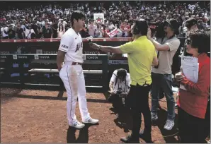  ?? KEVORK DJANSEZIAN/GETTY IMAGES ?? The Angels’ Shohei Ohtani (17) speaks with a Japanese television reporter after a win on May 21 in Anaheim.