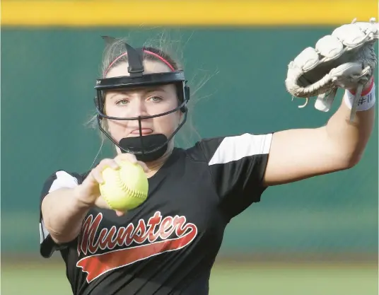  ?? JOHN SMIERCIAK/POST-TRIBUNE ?? Munster’s Mady Kindy pitches against Highland during a game in the first round of the Class 4A Lake Central Sectional on Tuesday. Munster won 4-0.