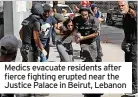  ?? ?? Medics evacuate residents after fierce fighting erupted near the Justice Palace in Beirut, Lebanon