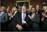  ?? JACQUELYN MARTIN — THE ASSOCIATED PRESS ?? House Ways and Means Chairman Rep. Kevin Brady, R-Texas, center, is welcomed by House Republican­s following a vote on the GOP tax bill Thursday in Washington.