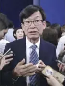  ??  ?? SEOUL: Kim Sang-jo, an economist, talks with reporters after a press conference at the presidenti­al Blue House in Seoul, South Korea yesterday. — AP