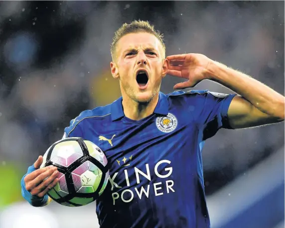  ??  ?? Jamie Vardy celebrates after opening the scoring for Leicester against Swansea yesterday