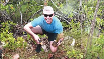  ?? FERNANDO BRETOS/Special to The Okanagan Weekend ?? Reporter Steve MacNaull plants cord grass in the mangrove along the Oleta River in Miami as part of the Frost Museum of Science’s Museum Volunteers for the Environmen­t (MUVE) program.