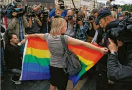  ?? ASSOCIATED PRESS/FILE ?? An activist held a pride flag during a protest in Russia. Such actions could now be criminally prosecuted.