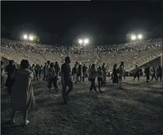  ??  ?? Spectators leave the ancient theater of Epidaurus after a concert July 17.