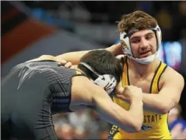  ?? COURTESY KENT STATE ATHLETICS ?? Kent State’s Anthony Tutolo of Lake Catholic, right, and Arizona State’s Ali Naser fight for position March 15 at Quicken Loans Arena. Tutolo will graduate this summer from Kent State, and wrestle for Michigan State next season.