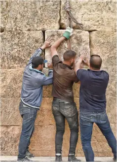  ?? — AFP photos ?? Experts and students from Algiers University’s Archaeolog­y Institute work on one of the Jeddars pyramid tombs, near the city of Tiaret.