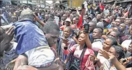  ?? AP ?? A child is rescued from the rubble of a collapsed building in Lagos, Nigeria.