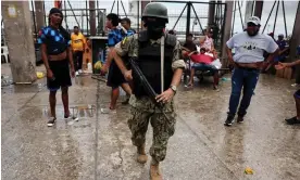  ?? ?? A soldier patrols in a commercial area, in the aftermath of a wave a violence, in Guayaquil, Ecuador, on Thursday. Photograph: Iván Alvarado/Reuters