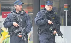  ??  ?? BELOW Armed police on guard duty near Borough Market on Sunday.
