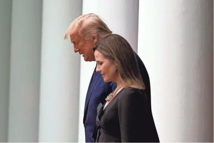  ?? ALEX BRANDON/AP ?? President Donald Trump and Judge Amy Coney Barrett head to the White House Rose Garden on Sept. 26 for a ceremony to introduce her as his nominee to fill Ruth Bader Ginsburg’s seat on the Supreme Court.