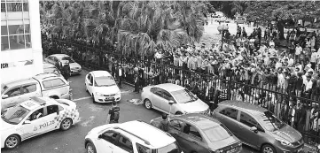  ??  ?? Shafie’s supporters gathered outside the Kota Kinabalu court house yesterday.