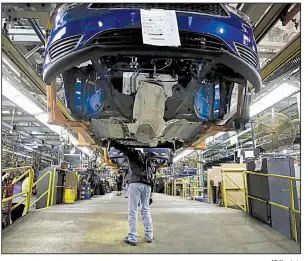  ?? AP file photo ?? An assembly line hums along last month at a Ford plant in Wayne, Mich. A rebound in demand for commercial and military aircraft helped fuel November’s increase in orders for durable goods.