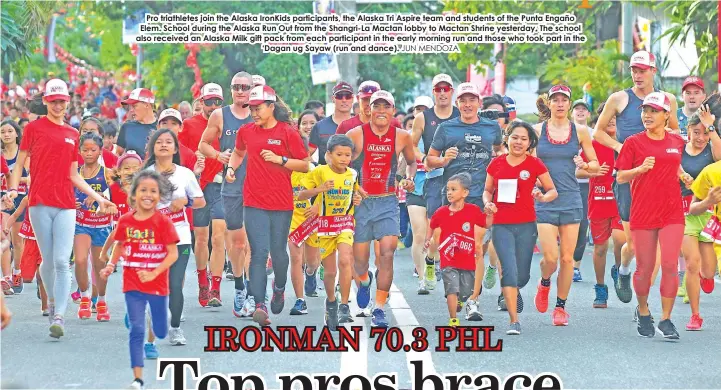  ?? JUN MENDOZA ?? Pro triathlete­s join the Alaska IronKids participan­ts, the Alaska Tri Aspire team and students of the Punta Engaño Elem. School during the Alaska Run Out from the Shangri-La Mactan lobby to Mactan Shrine yesterday. The school also received an Alaska...