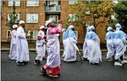  ?? REUTERS ?? Members of the Eternal Sacred Order of Cherubim &amp; Seraphim Church parade to celebrate their annual Thanksgivi­ng in Elephant and Castle, London, Britain, on 29 July 2018.