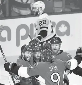  ?? Peter Diana Associated Press ?? DERICK BRASSARD, left, celebrates his first-period goal with Senators teammates Clarke MacArthur (16), Bobby Ryan and Marc Methot (3).