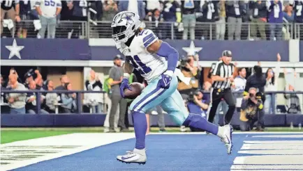  ?? RAYMOND CARLIN III/USA TODAY SPORTS ?? Cowboys running back Ezekiel Elliott reacts after scoring the winning touchdown against the Texans in the last minute at AT&T Stadium.