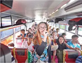  ?? SUNSTAR FOTO / AMPER CAMPAÑA ?? SINGING HER HEART OUT. A passenger who gets a score of 100 in this bus’ videoke gets not just the attention of other passengers, but a free ride to Sibonga or Carcar as well.