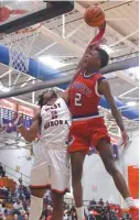  ?? | WORSOM ROBINSON/ FOR THE SUN- TIMES ?? West Aurora’s Camron Donatlan fouls Curie’s Dajuan Gordon on his way to the hoop.