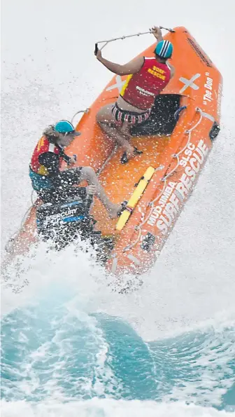  ?? Picture: HARVPIX ?? Mudjimba’s boat flies high. And (top) North Burleigh watch a rival in the water.