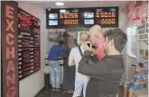  ?? AP PHOTO ?? CURRENCY CONCERN: A man checks foreign currency exchange rates in Istanbul on Friday as a financial shockwave ripped through Turkey.