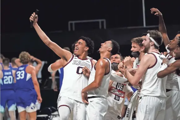  ?? KIRBY LEE/USA TODAY SPORTS ?? Forward Corey Kispert, guard Julian Strawther, guard Jalen Suggs and forward Drew Timme celebrate Gonzaga’s WCC tournament title.