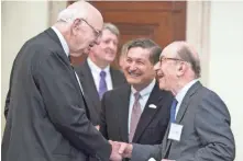  ?? FILE PHOTO BY JAY WESTCOTT FOR USA TODAY ?? Former Fed chiefs Paul Volcker, left, and Alan Greenspan say their hellos as Jeffrey Lacker looks on ahead of an event commemorat­ing the signing of the Federal Reserve Act in 2013.