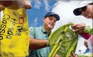  ?? RICHARD GRAULICH / THE PALM BEACH POST ?? Patrick Reed signs autographs during the Honda Classic practice rounds at PGA National in Palm Beach Gardens on Tuesday.