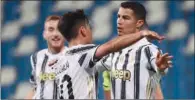  ?? (AFP) ?? Juventus’ Paulo Dybala (left) celebrates with Cristiano Ronaldo after the latter scored during the Italian Serie A match against Sassuolo at the Mapei-Citta del Tricolore stadium in Reggio Emilia on Wednesday.