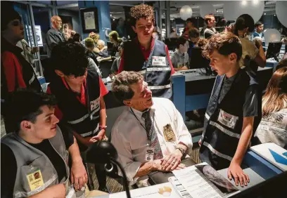  ?? Photos by Jon Shapley / Staff photograph­er ?? Tim White, center, talks with grandchild­ren, clockwise from right, Cooper, 10, Kale, 13, and Mason, 10, as well intern Conrad Schmitt, 17, at the Houston Museum of Natural Science on Thursday. White worked on the Apollo 8 mission.