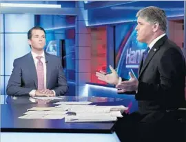  ?? Richard Drew Associated Press By Stephen Battaglio ?? FOX host Sean Hannity, right, interviews Donald Trump Jr. in July. The network has been friendly toward the president and his supporters.