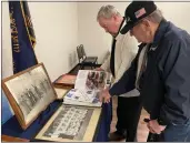  ?? DAVID ALLEN — STAFF ?? Jimmy Melton, right, points to an item as Dick DuPlain flips through pages of a scrapbook at Ontario’s American Legion Post 112on Wednesday. The post has relocated after 70 years to a new building, which will be dedicated Saturday.