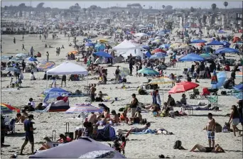  ?? MARCIO JOSE SANCHEZ — THE ASSOCIATED PRESS FILE ?? In this May 24, 2020, file photo, visitors gather on the beach in Newport Beach during the coronaviru­s outbreak.