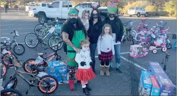  ?? Alex Maclean / Union Democrat ?? Family members of the late Koltyn Sparks-blackwood (above, from left) Angie Valentine, Matteah Valentine, Remi Medeiros,theresa Blackwood, Aubrey Burns, andtracy Gulcynski gave away dozens of bicycles and toys to children in need on Saturday at the parking lot of the former Burger King on Mono Way in East Sonora. A custom motorcycle belonging to Joshua Blackwood, father of the late Koltyn Sparks-blackwood, featuring airbrushed images of his deceased son (above left).tracy Gulcynski, paternal grandmothe­r of the late Koltyn Sparks-blackwood, wears a hoodie (left) that promotes the family’s ongoing quest for justice in the toddler’s unsolved homicide death on Jan. 15, 2019.