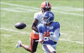  ?? Ron Schwane / Associated Press ?? New York Giants wide receiver Darius Slayton (86) catches a pass next to Cleveland Browns cornerback Troy Hill during a joint NFL training camp practice on Friday in Berea, Ohio.